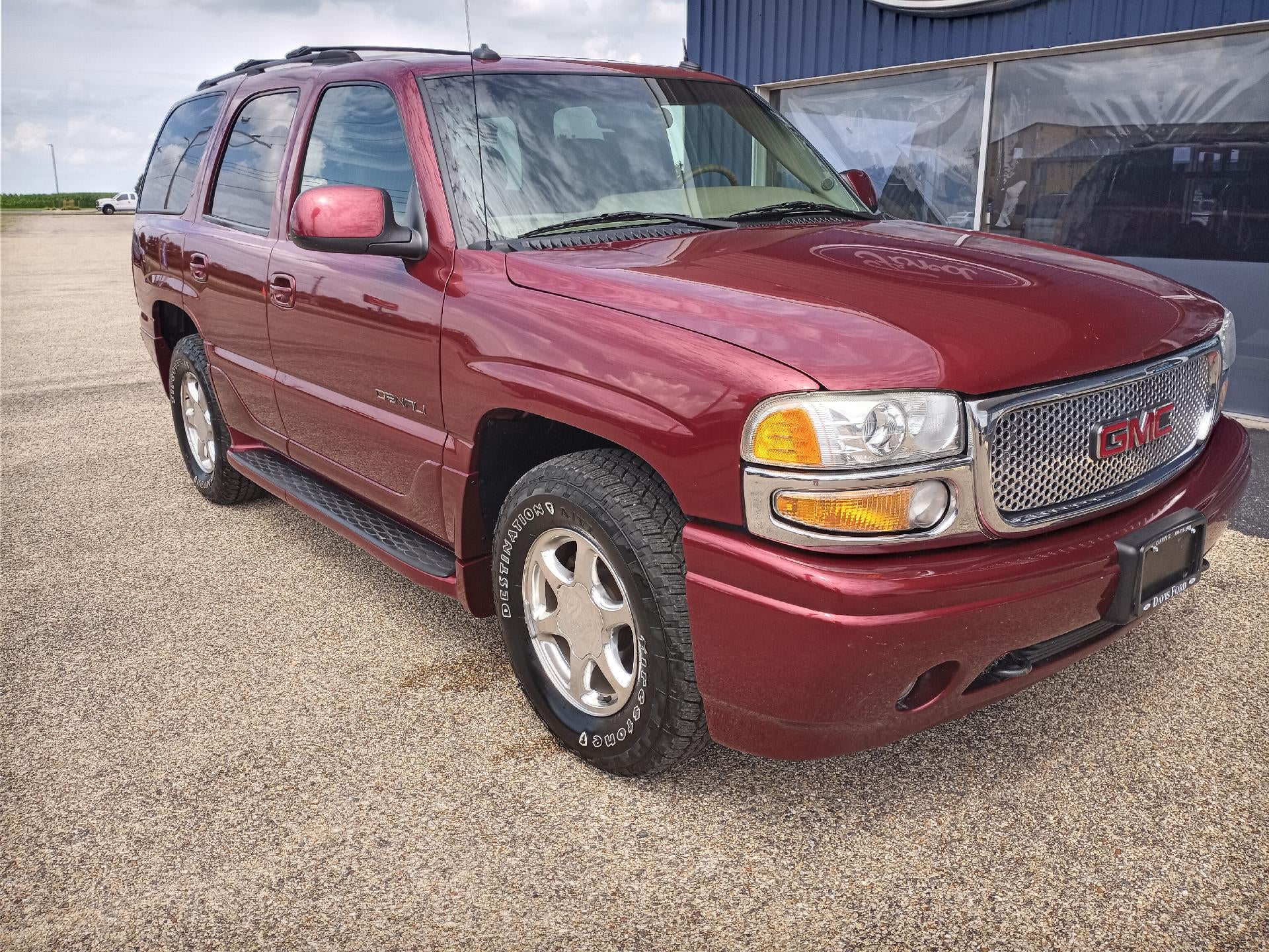 2003 GMC Yukon Denali 4dr AWD in Garnet Red Metallic — front three-quarter view